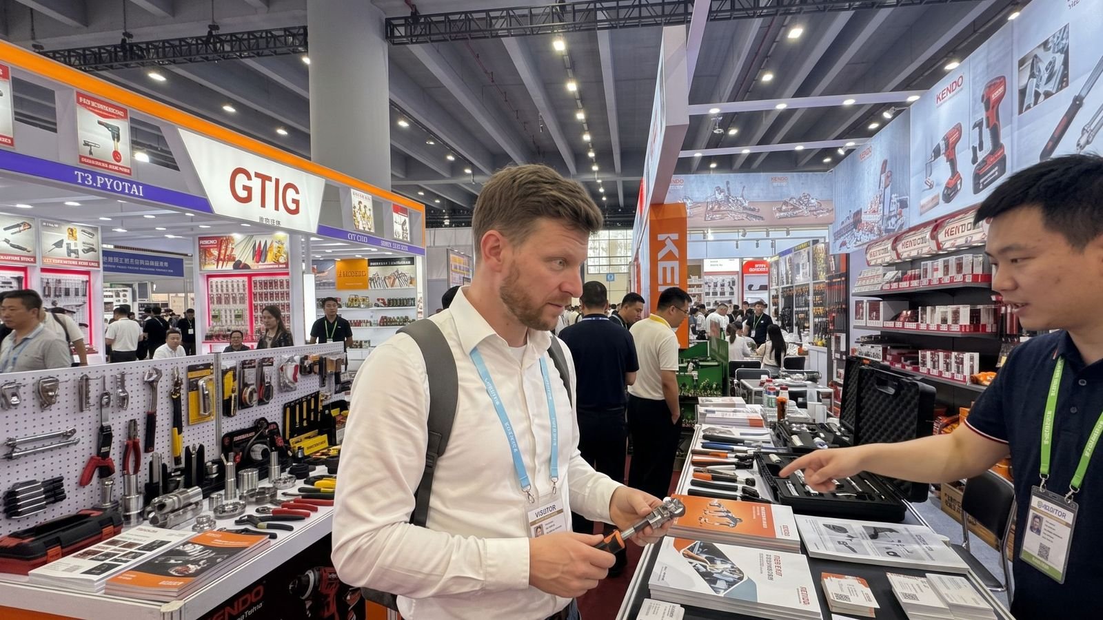 Charlie discussing a product sample with a supplier at a trade fair stand